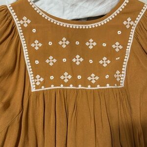 Yellow and embroidered blouse. Full sleeves, loose fitting.